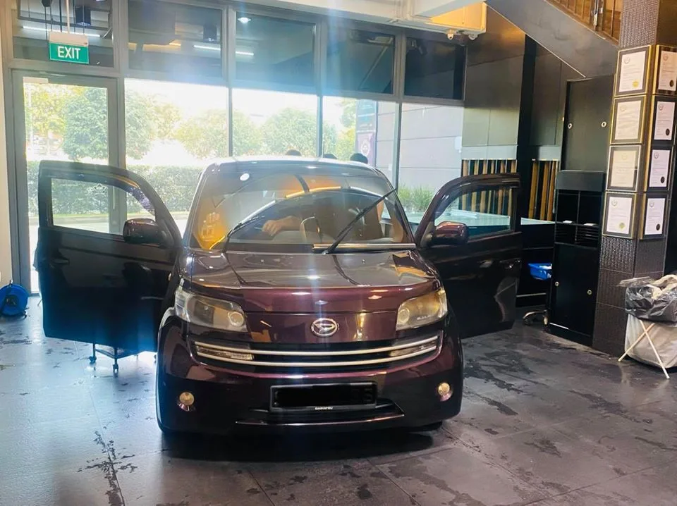 Maroon Daihatsu Materia front view with doors open inside the Infratint Singapore showroom