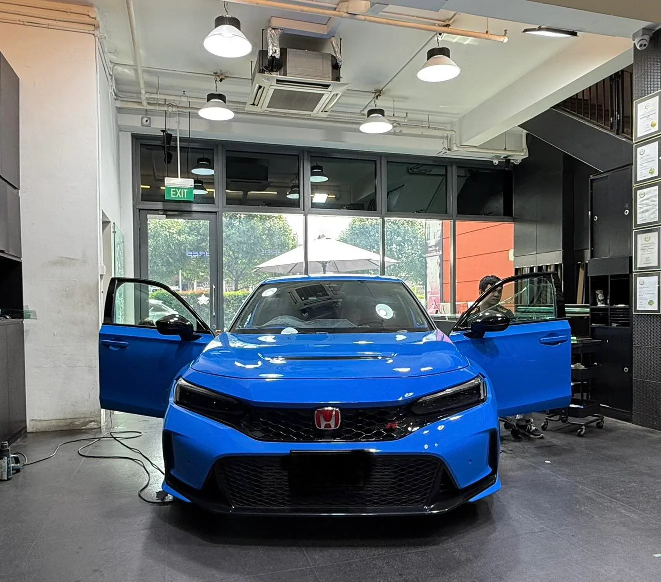 Blue Honda Civic Type R with front doors open inside the Infratint workshop