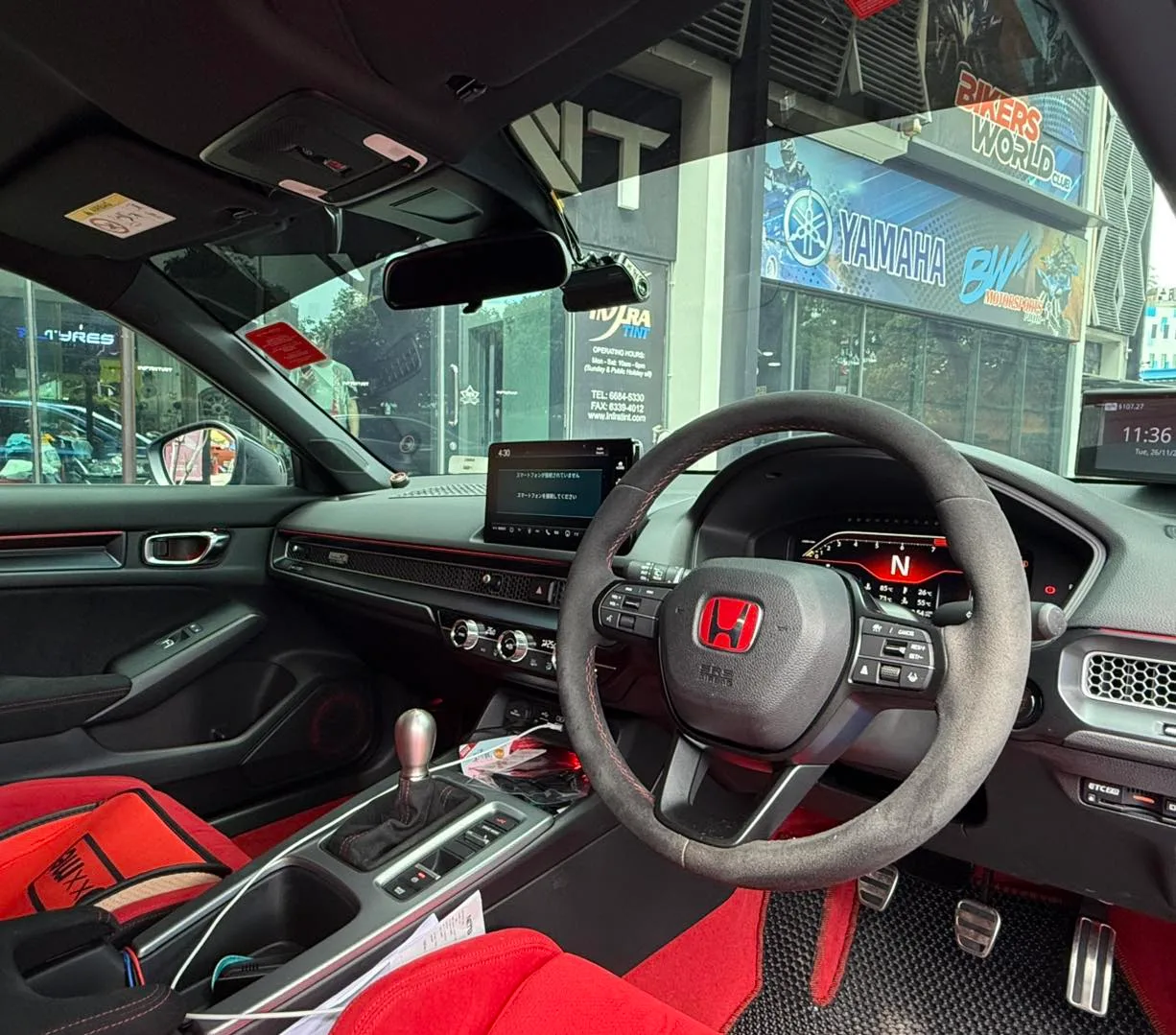 Honda Civic Type R interior with red seats and steering wheel seen through tinted glass at Infratint Singapore