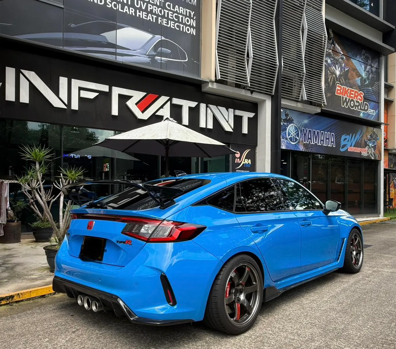 Blue 2024 Honda Civic Type R rear three-quarter view with rear wing outside Infratint Singapore