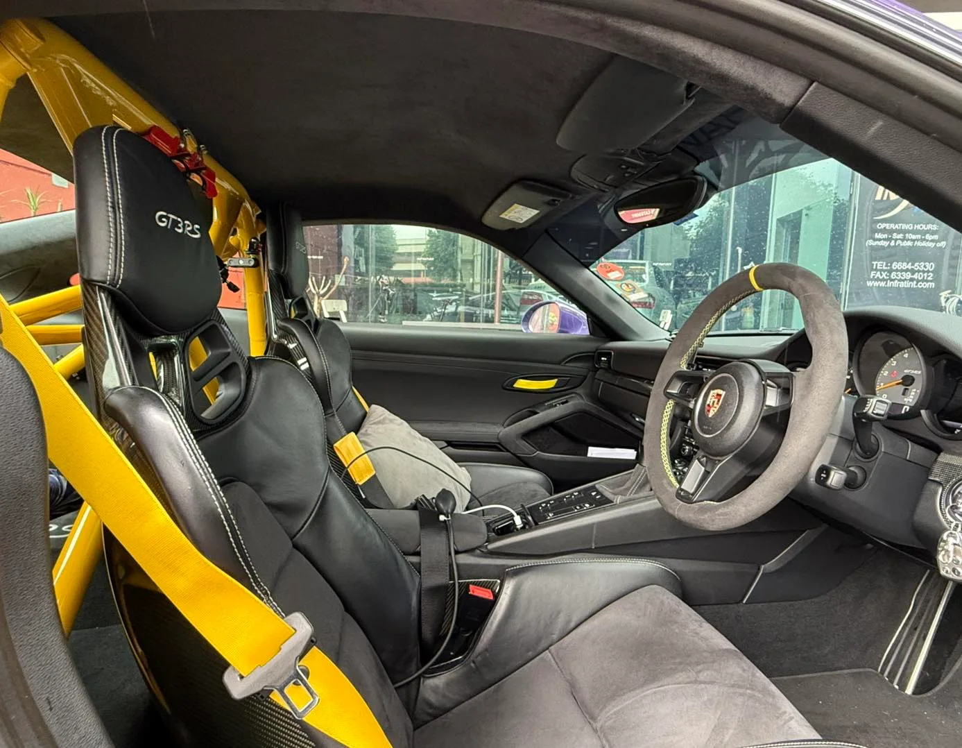 Porsche GT3 RS bucket seat and roll cage seen through tinted glass at Infratint Singapore