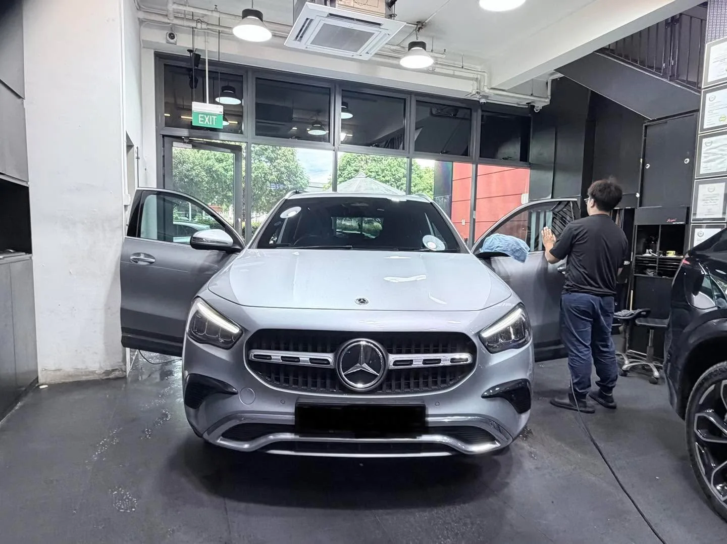 A silver Mercedes-Benz SUV facing the camera in the workshop.
