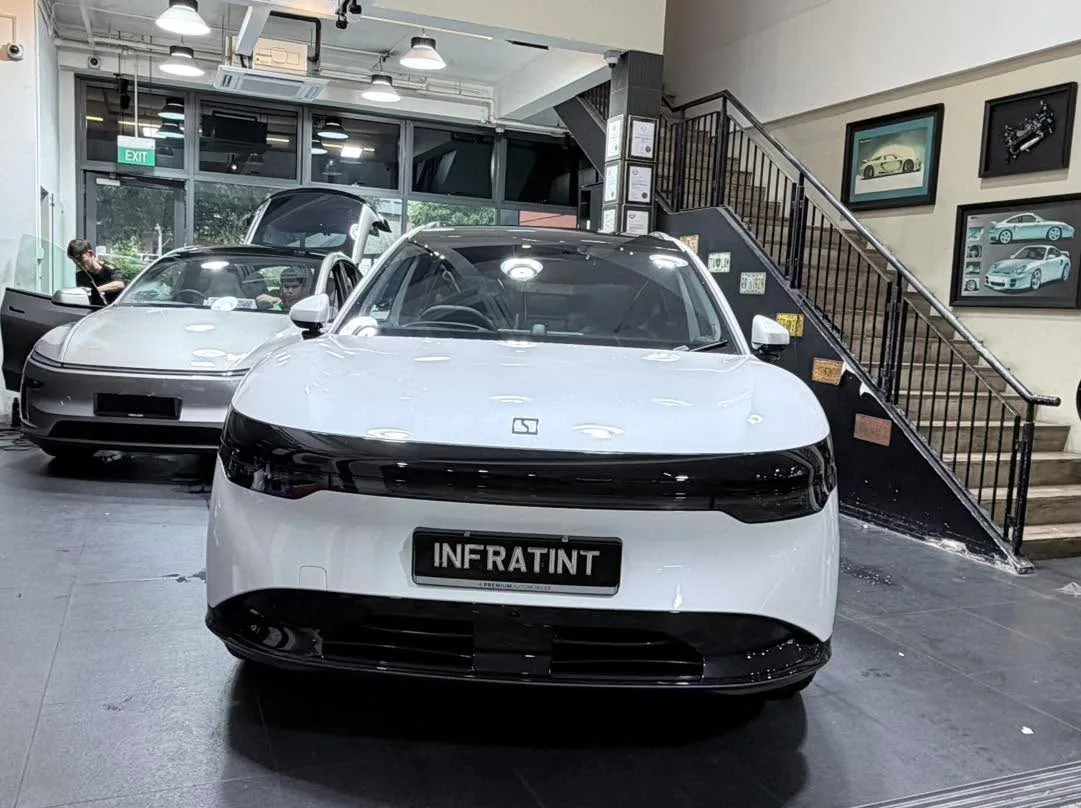 A white Tesla sedan parked in the showroom.