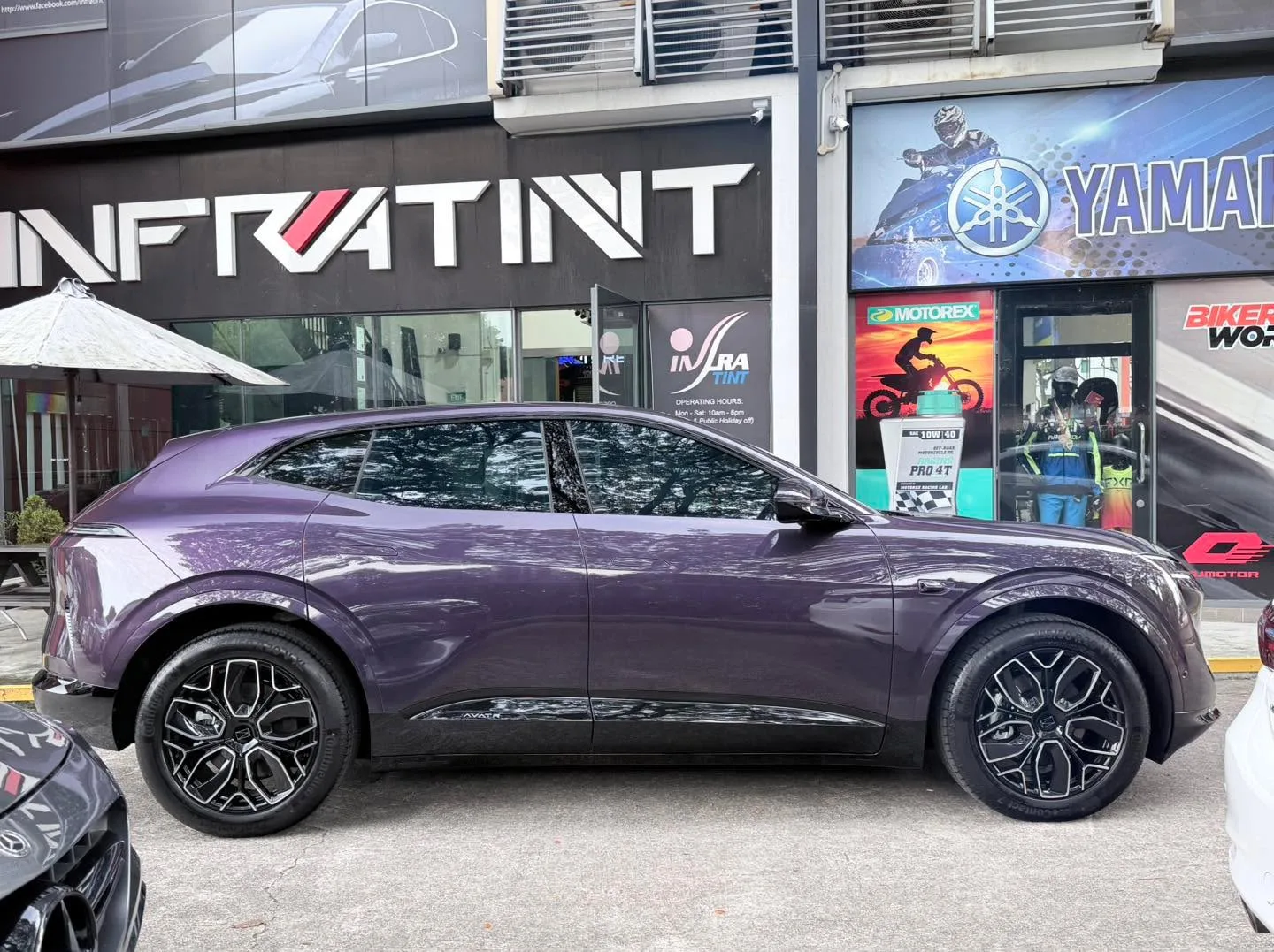 A side view of the purple Avatr 07 parked outside the Infratint workshop.