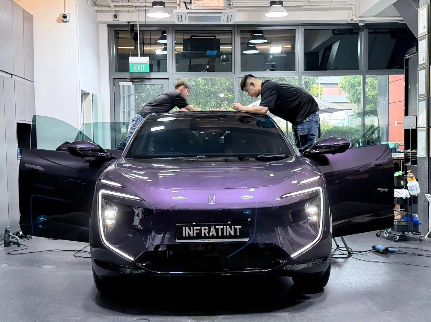 Technicians working on the Avatr 07 inside the Infratint workshop bay.