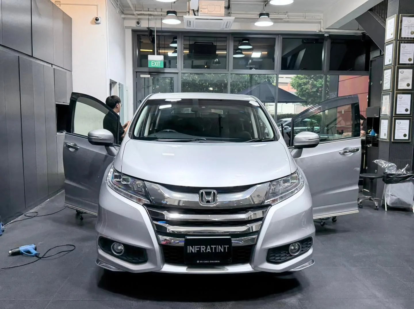 A silver Honda Shuttle minivan viewed from the front at the workshop.