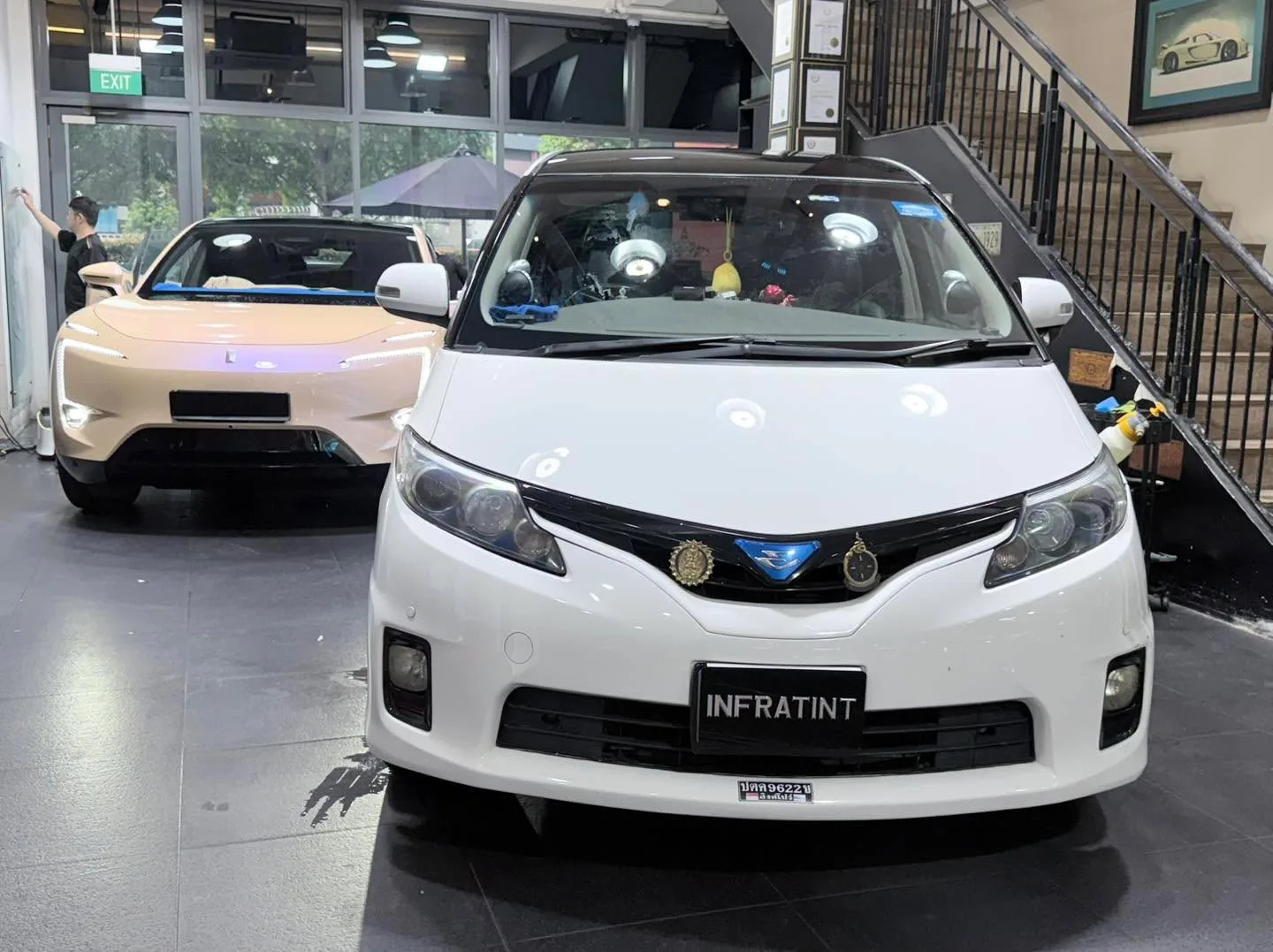A beige Avatr 11 electric sedan parked indoors with its door open.