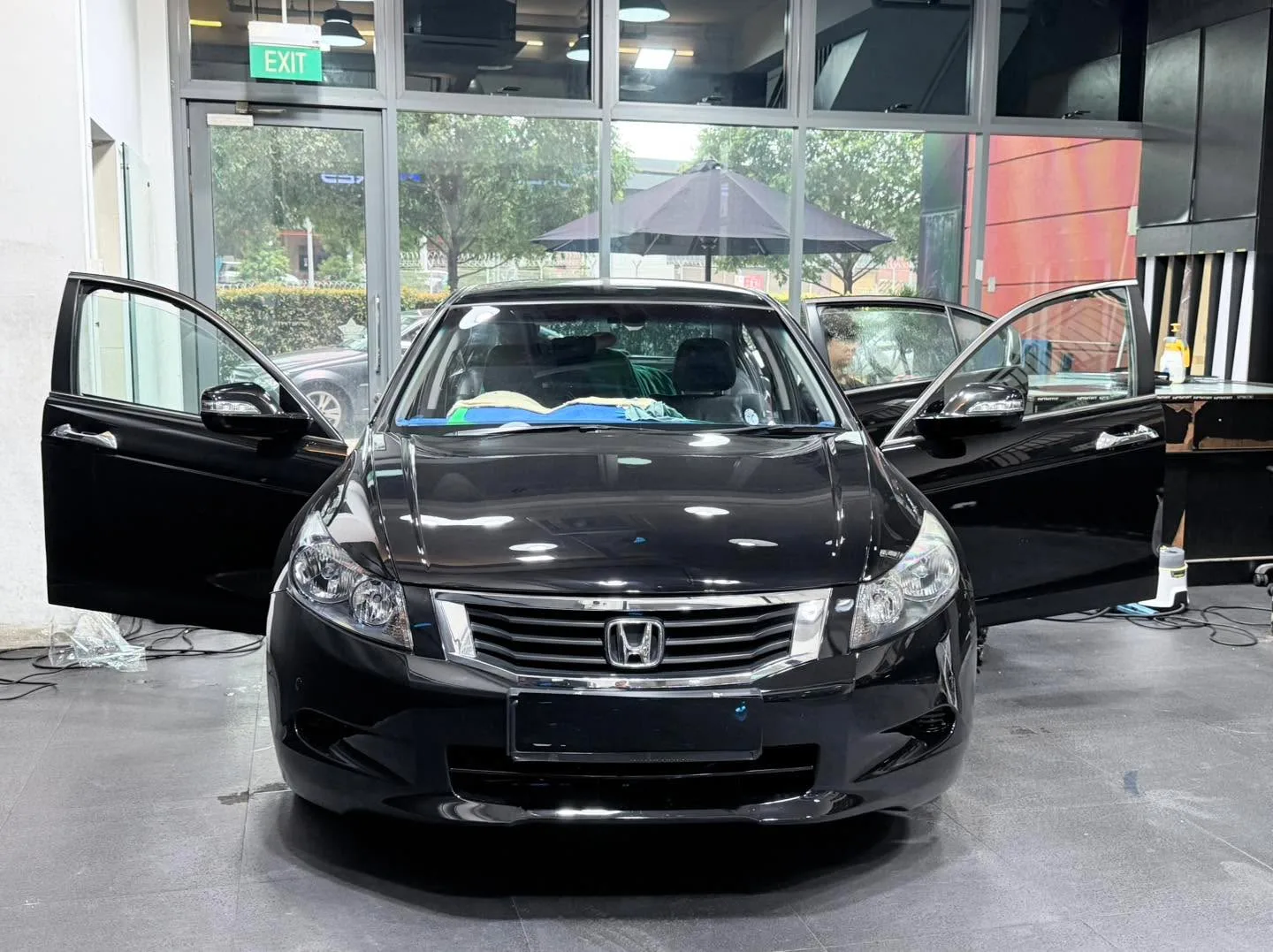 A black Honda Vezel with doors open displayed indoors.