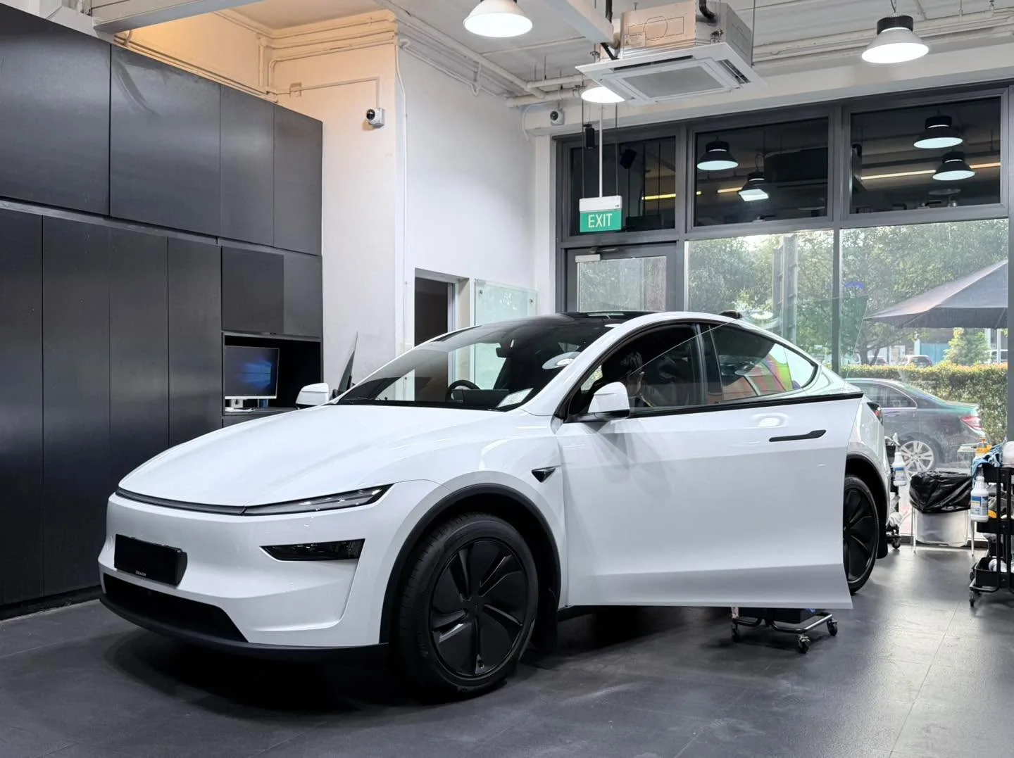 White Tesla electric SUV inside the workshop.