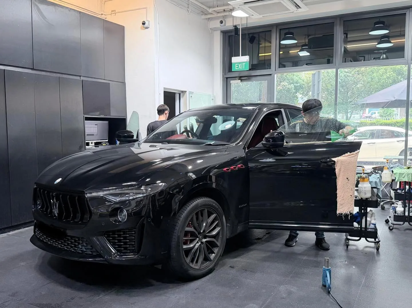 A white Hyundai SUV with doors open during window tinting.