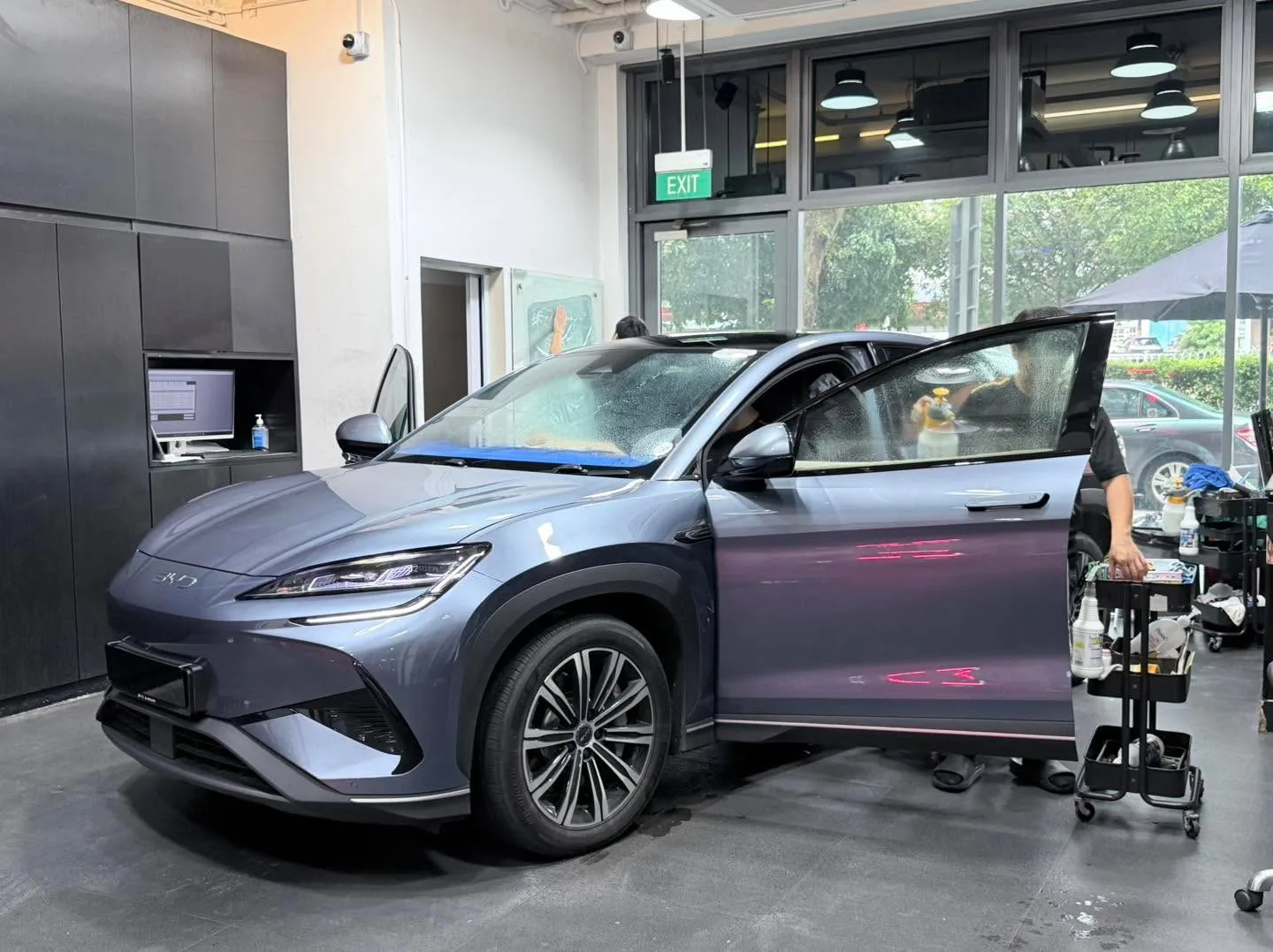 A black SUV with distinctive grille and angular headlights in the workshop.