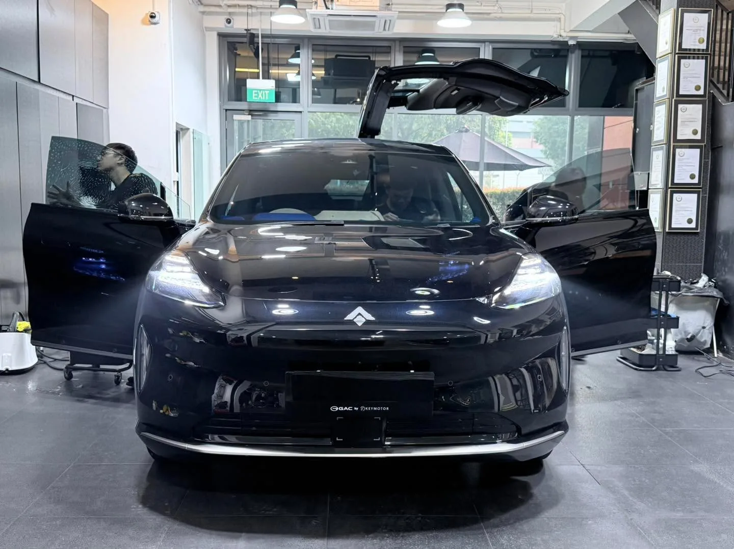 A black Citroën SUV with its doors open, receiving window tint treatment.