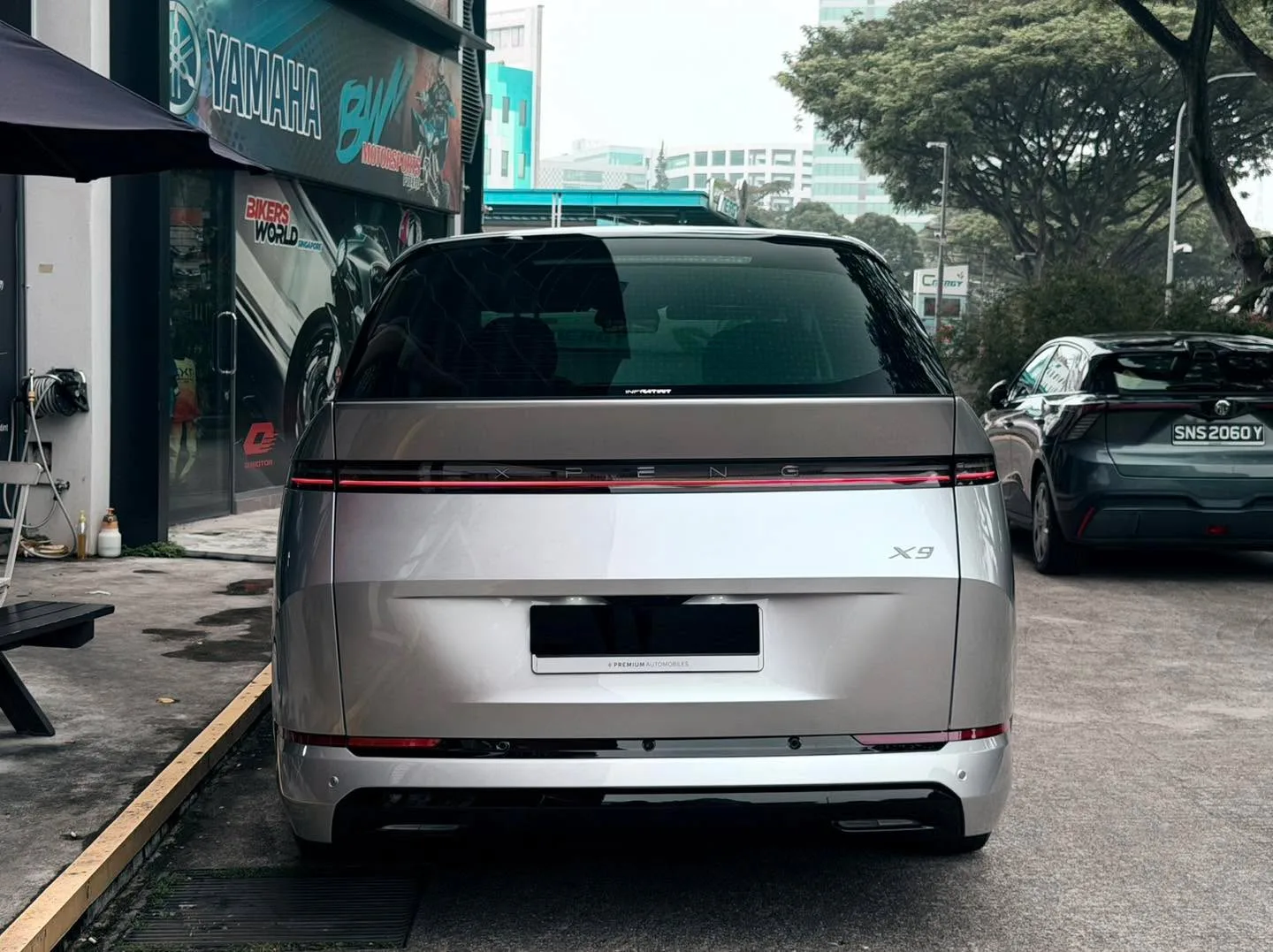 White XPENG X9 photographed from rear, showing X9 badge and tinted rear windows.