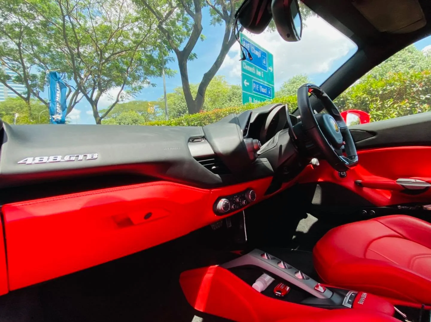 Ferrari 488 GTB dashboard badge and red interior at Infratint Singapore