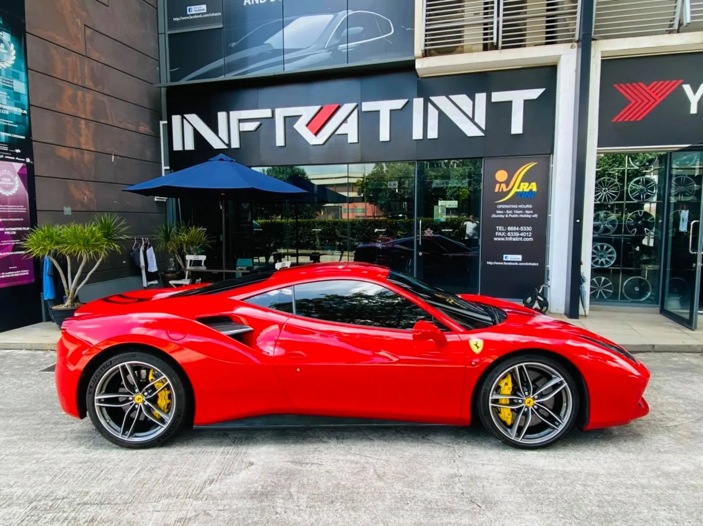 Red Ferrari 488 GTB side profile outside Infratint Singapore