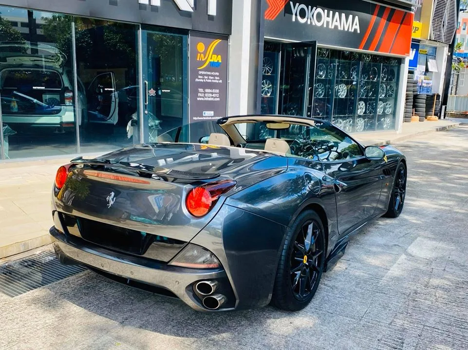 Rear three-quarter of a grey Ferrari California convertible at Infratint Singapore
