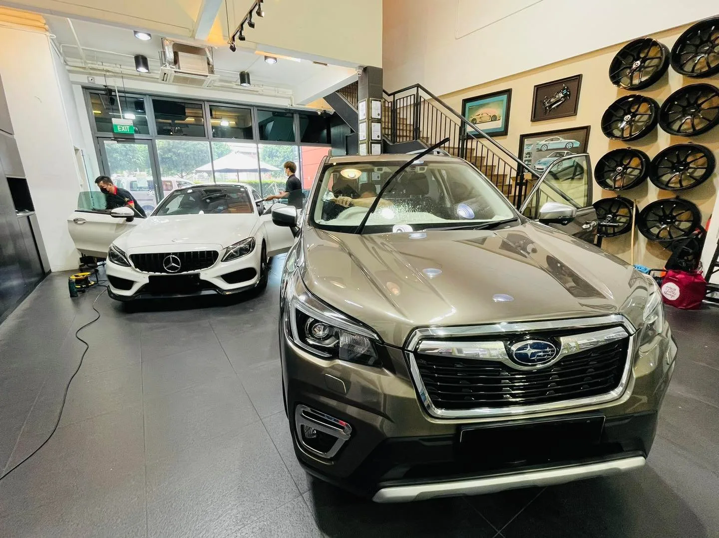 Bronze Subaru Forester and a white Mercedes-Benz at Infratint Singapore for window film