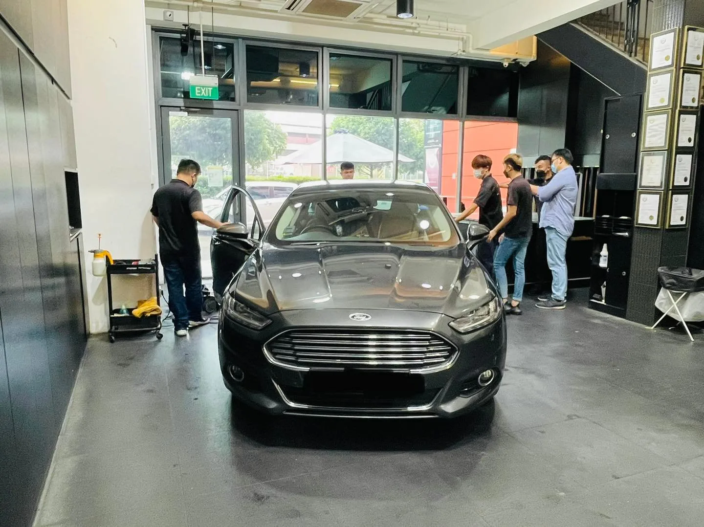 Grey Ford Mondeo with installers working around it at Infratint Singapore