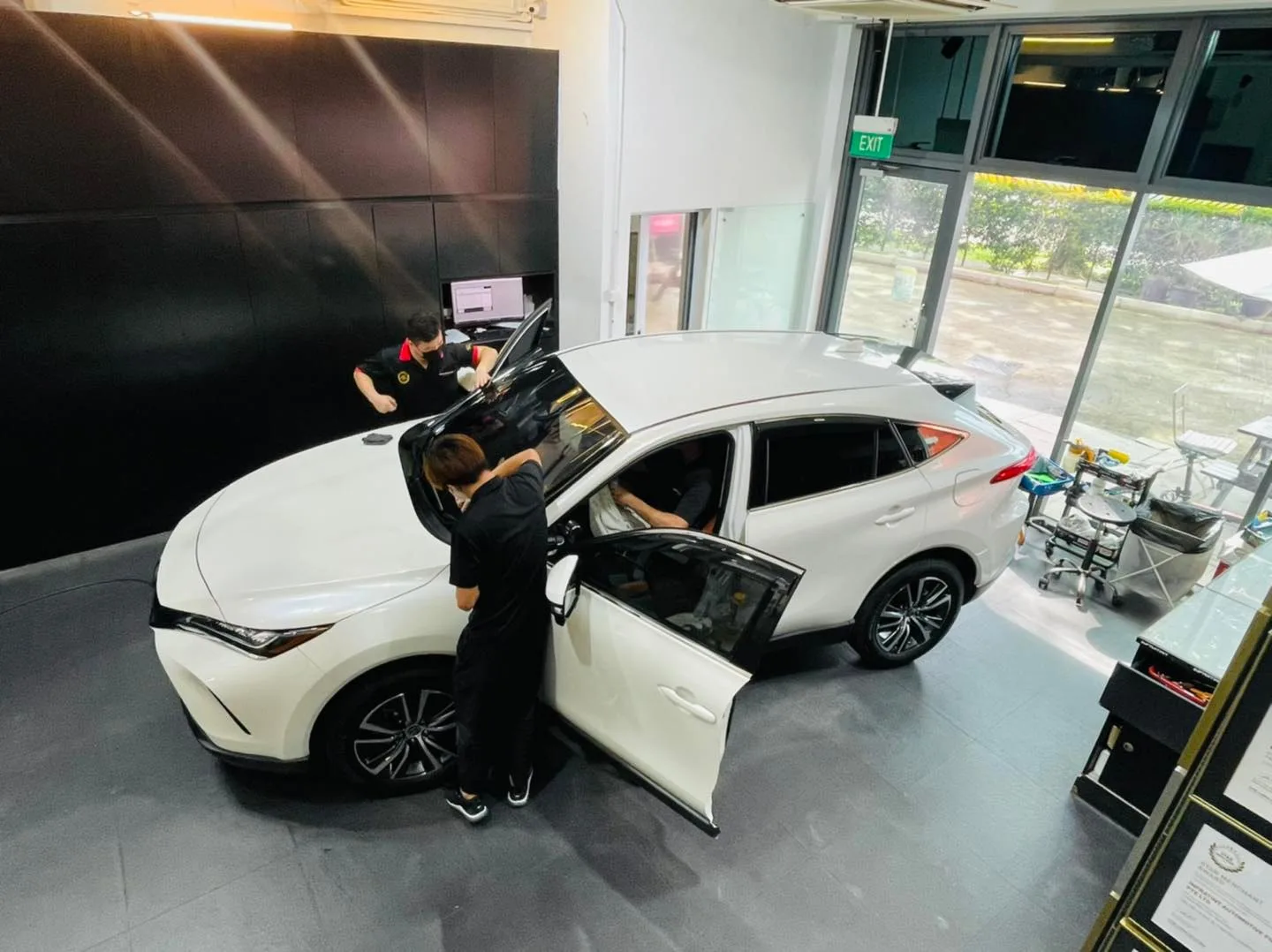 Overhead view of window tinting on a white Toyota Harrier at Infratint Singapore
