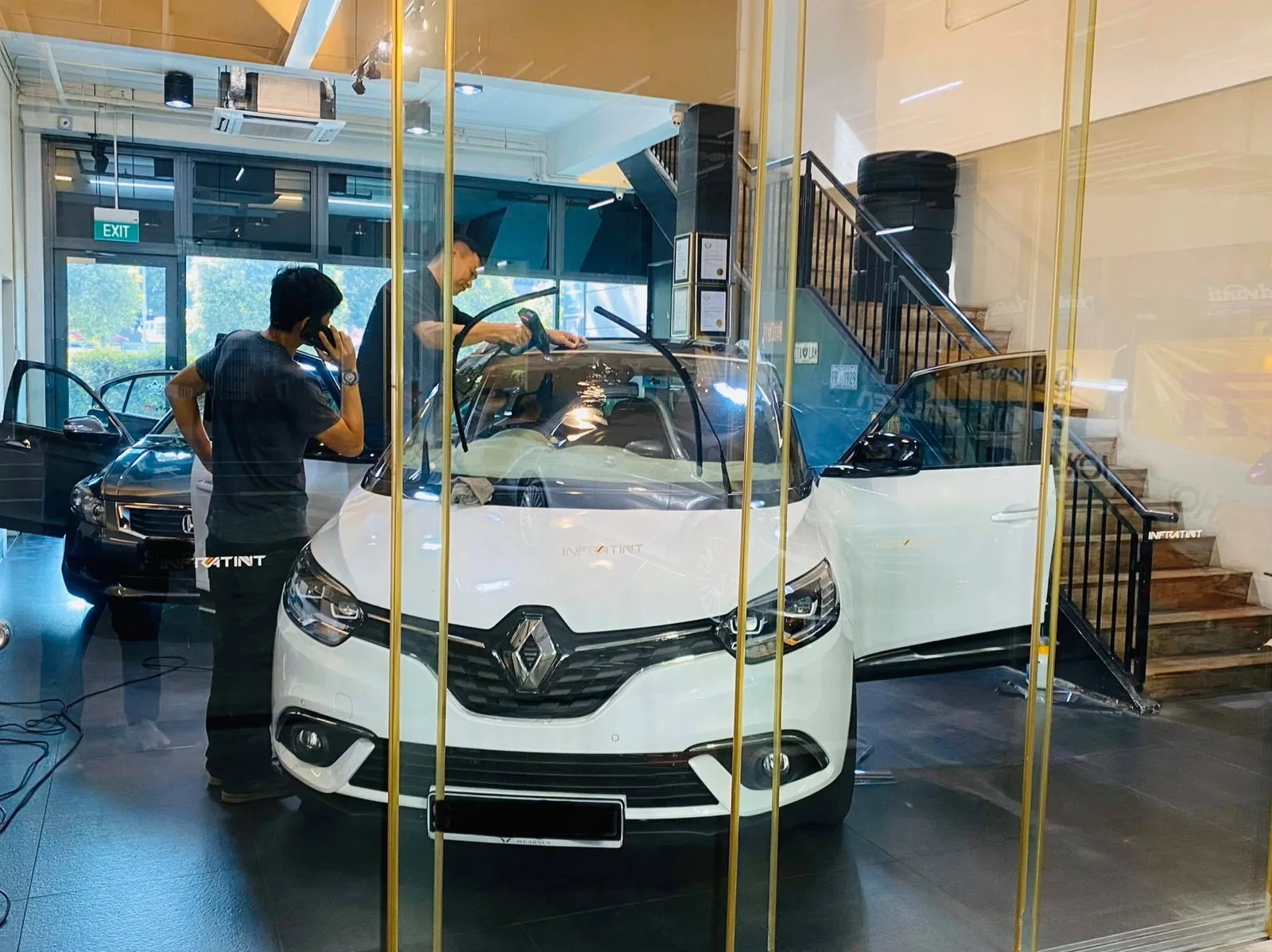 White Renault Grand Scenic getting window tint installed at Infratint Singapore