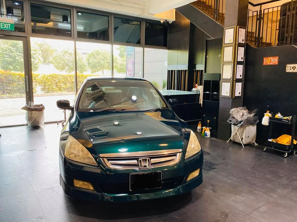 Dark green Honda Accord viewed head-on inside the Infratint workshop bay