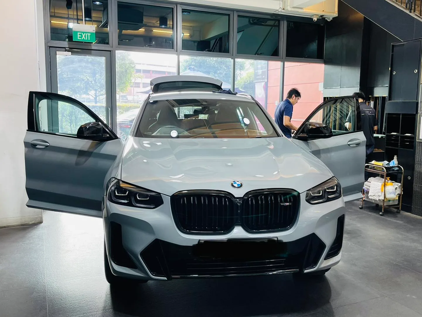 Grey BMW X4 front view with doors open at Infratint Singapore window tinting