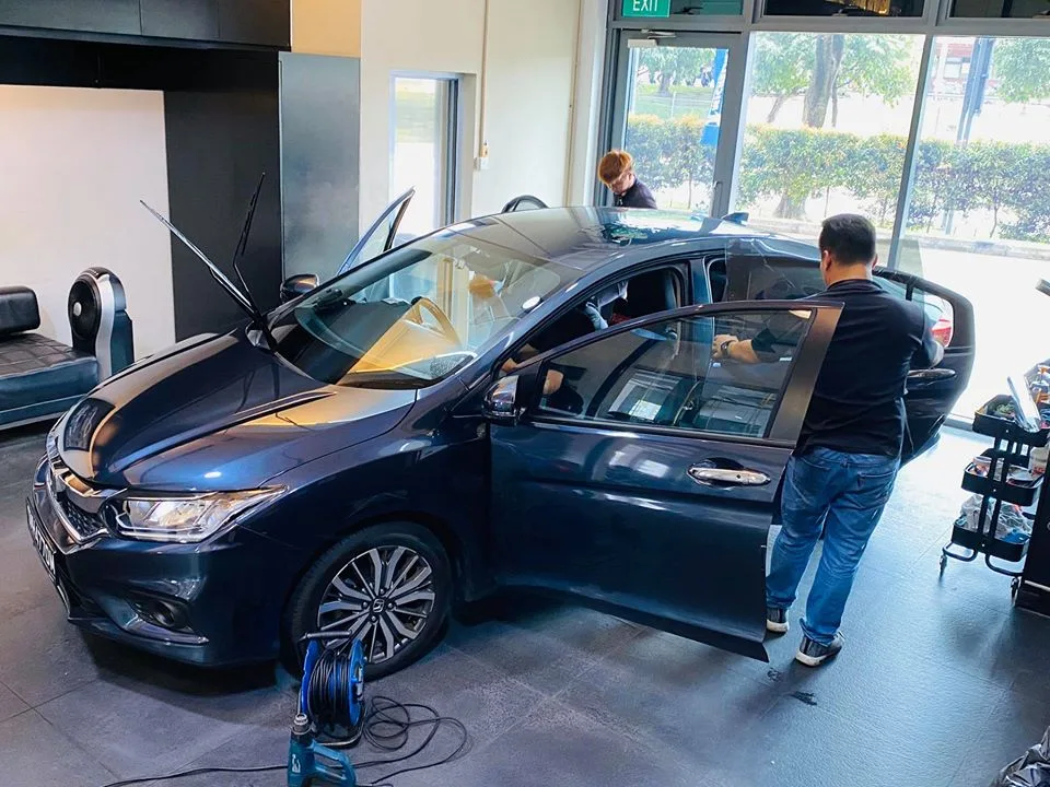 Dark blue Honda sedan having its door glass tinted at Infratint Singapore