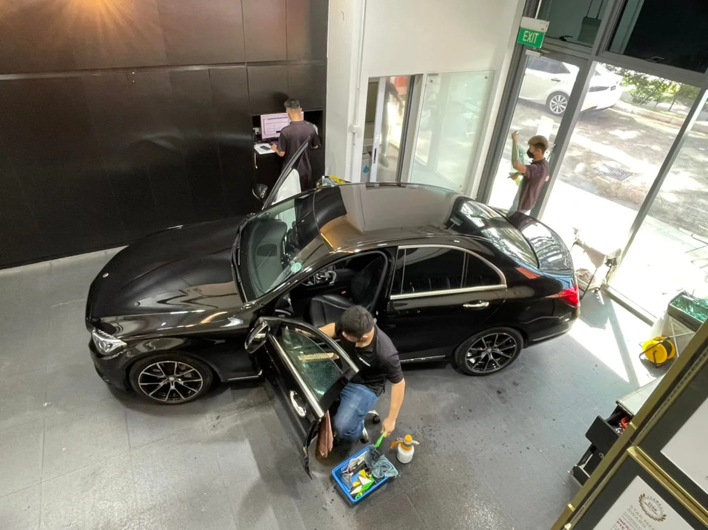Overhead view of a black Mercedes-Benz sedan being tinted at Infratint Singapore