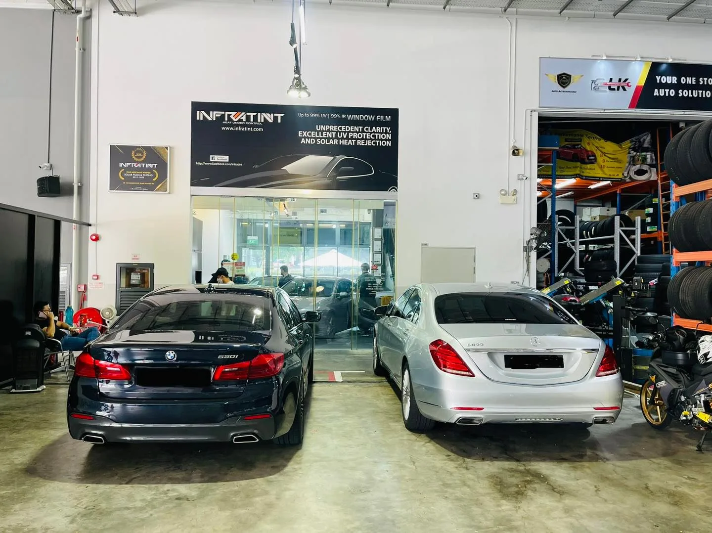 Grey BMW 5 Series and silver Mercedes-Benz S-Class inside the Infratint Singapore workshop
