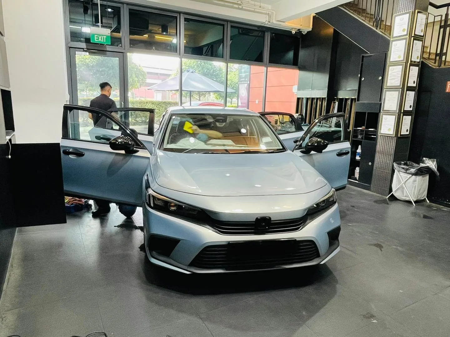Silver Honda Civic with doors open during window film install at Infratint Singapore