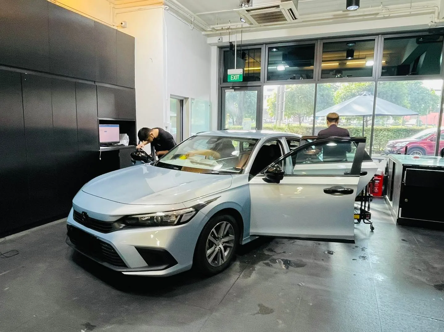 Silver Honda Civic front three-quarter view during window tinting at Infratint Singapore