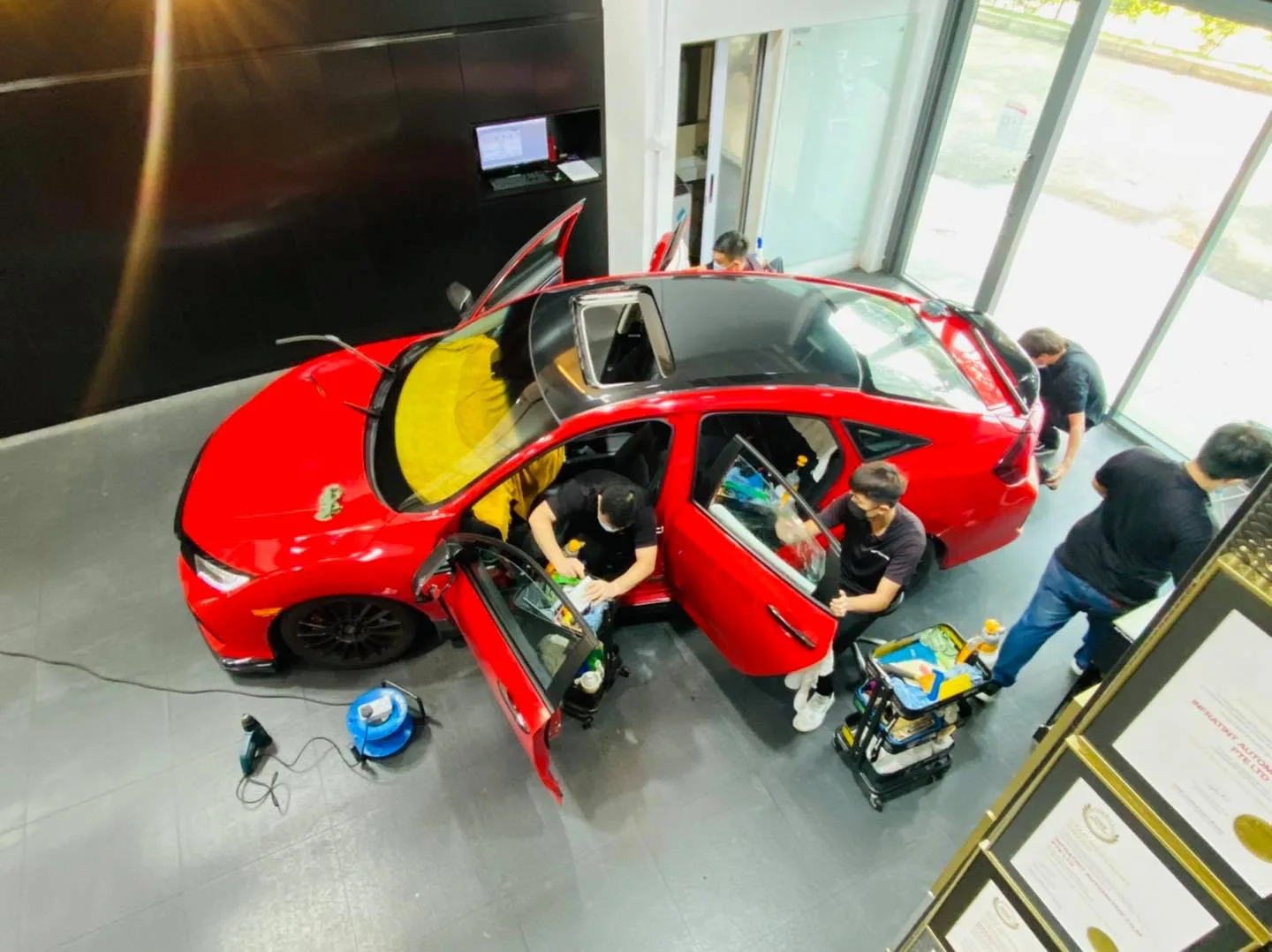 Overhead view of a red Honda Civic Type R window tinting at Infratint Singapore