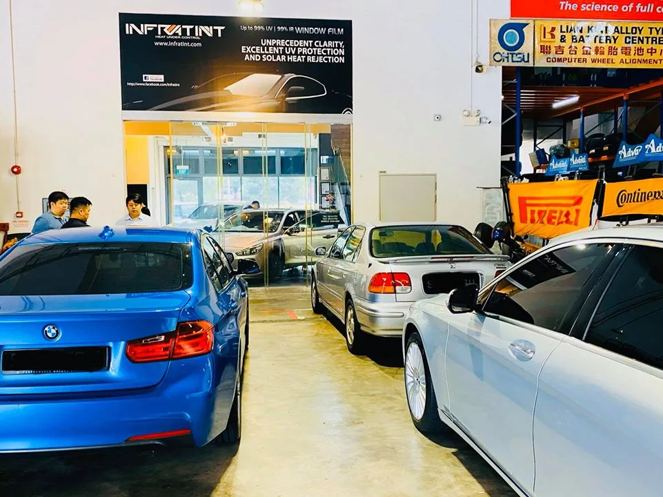 Blue BMW 3-Series, silver Honda Civic and Mercedes-Benz sedan parked inside the Infratint Singapore install bay