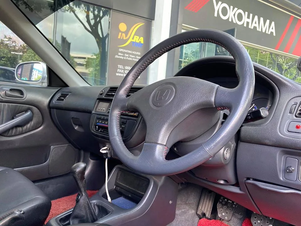 Interior dashboard and steering wheel of a Honda Civic at Infratint Singapore