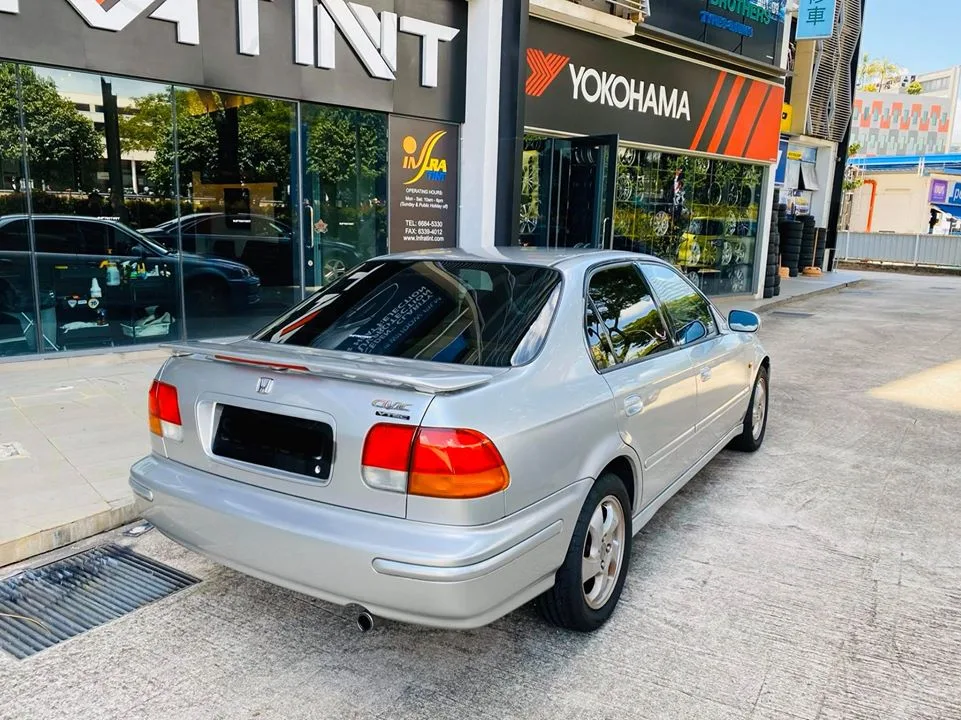 Rear three-quarter of a silver Honda Civic sedan with tinted windows at Infratint Singapore