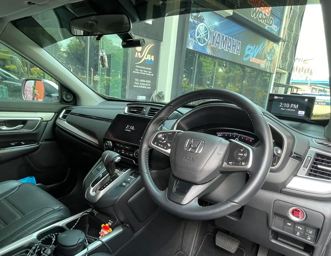 Honda CR-V dashboard and steering wheel seen through tinted windscreen at Infratint Singapore