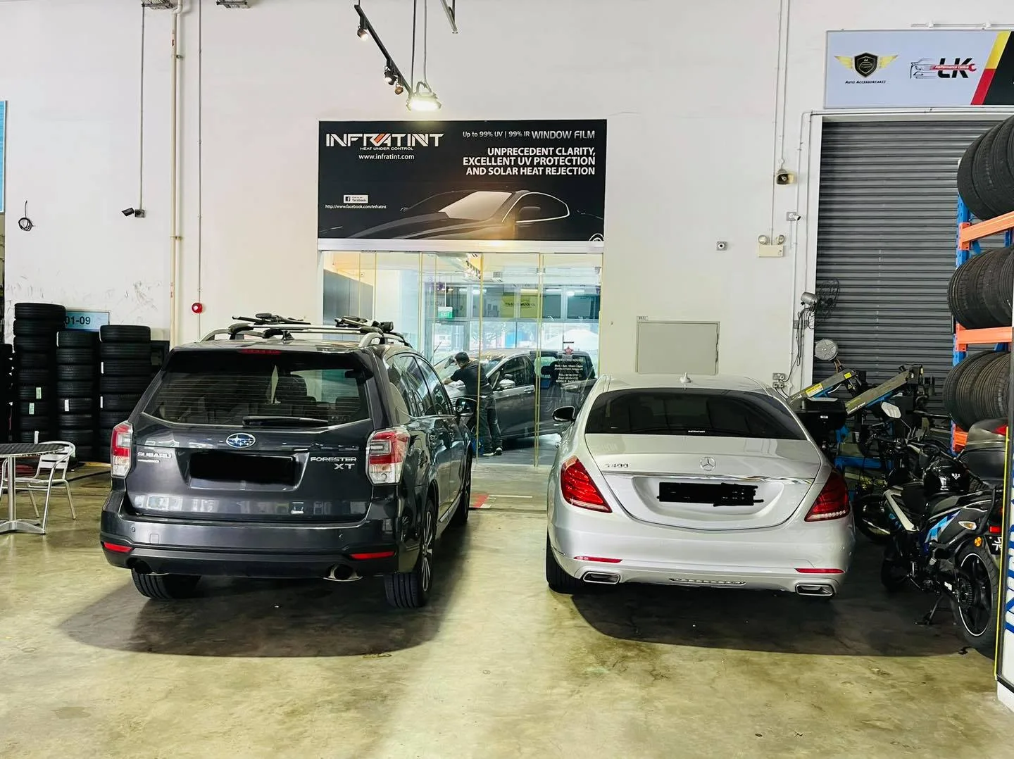 Grey Subaru Forester and silver Mercedes-Benz sedan in the install bay at Infratint Singapore