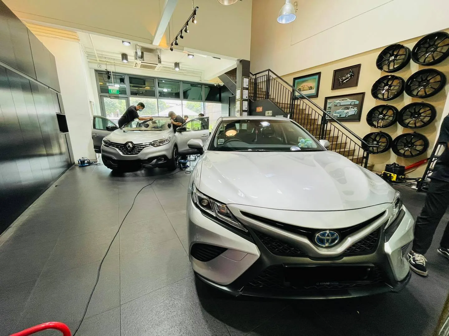 Silver Toyota Camry in the showroom during window tinting at Infratint Singapore