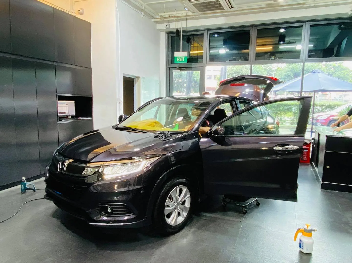Black Honda HR-V with door open inside the Infratint Singapore showroom before tinting