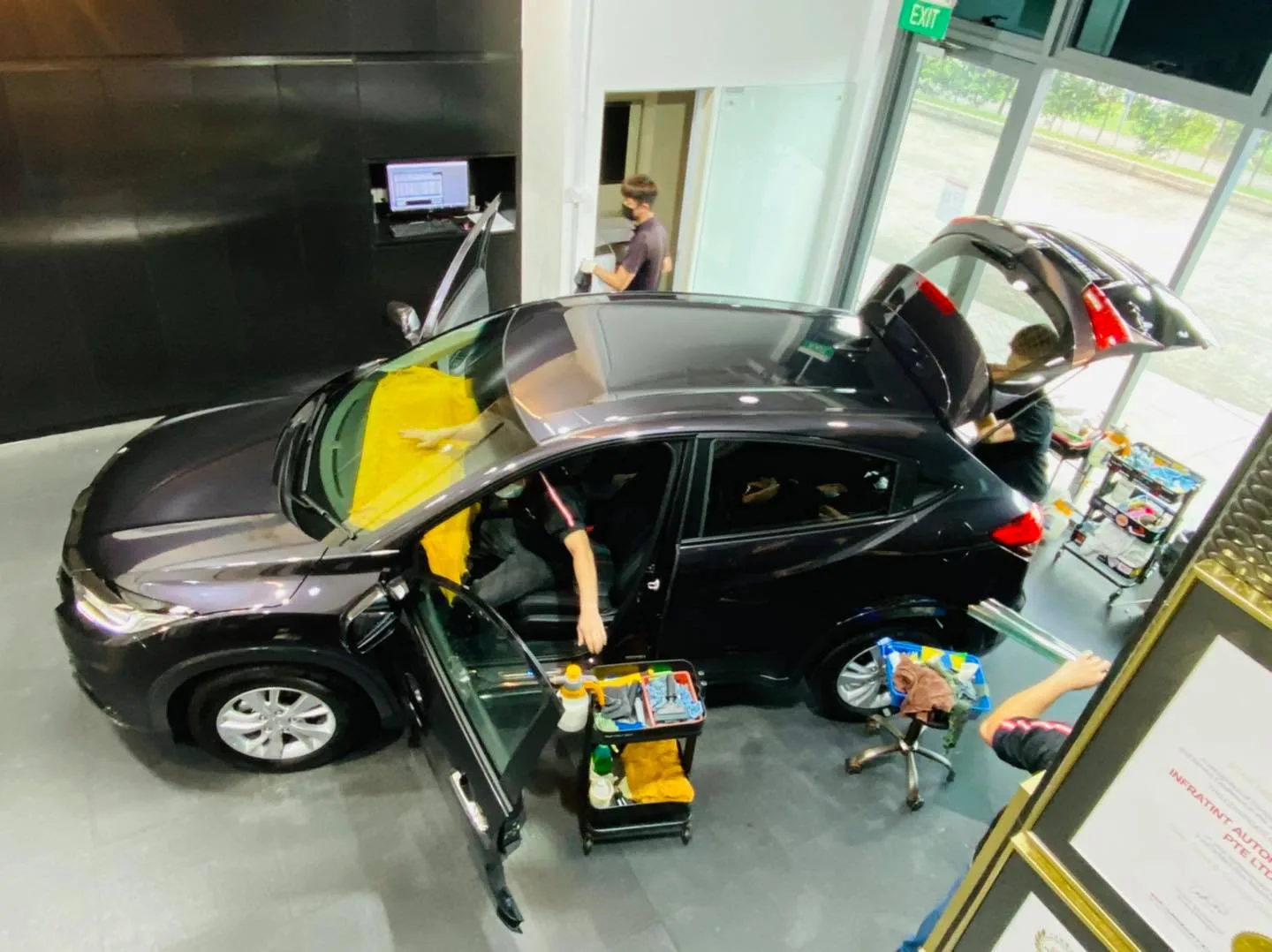 Overhead view of two installers tinting a black Honda HR-V at Infratint Singapore