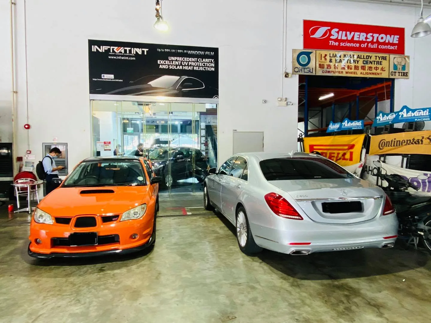 Orange Subaru WRX beside a silver Mercedes-Benz S-Class at Infratint Singapore