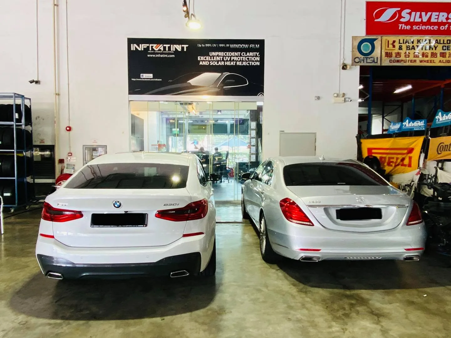White BMW 630i GT and silver Mercedes-Benz S-Class parked at Infratint Singapore