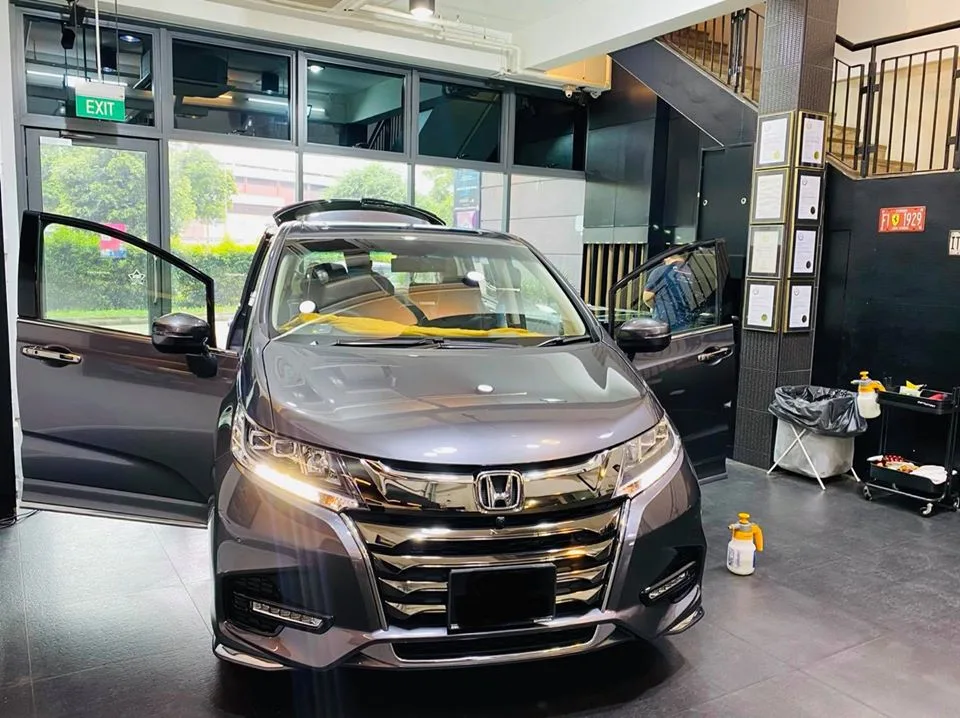 Grey Honda Odyssey with doors open for window tinting at Infratint Singapore