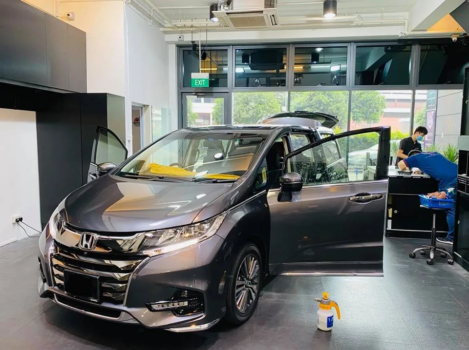 Grey Honda Odyssey MPV being prepared for tinting at Infratint Singapore
