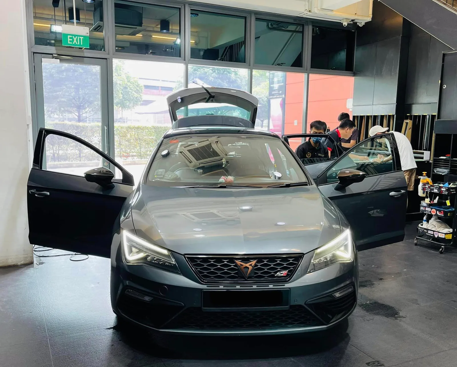Grey Cupra hatchback with doors open ready for solar film at Infratint Singapore