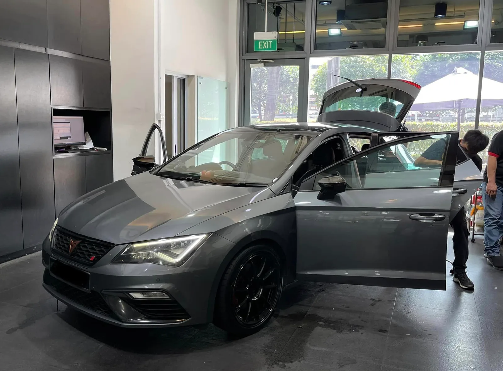 Grey Cupra hatchback being prepped for window tinting at Infratint Singapore