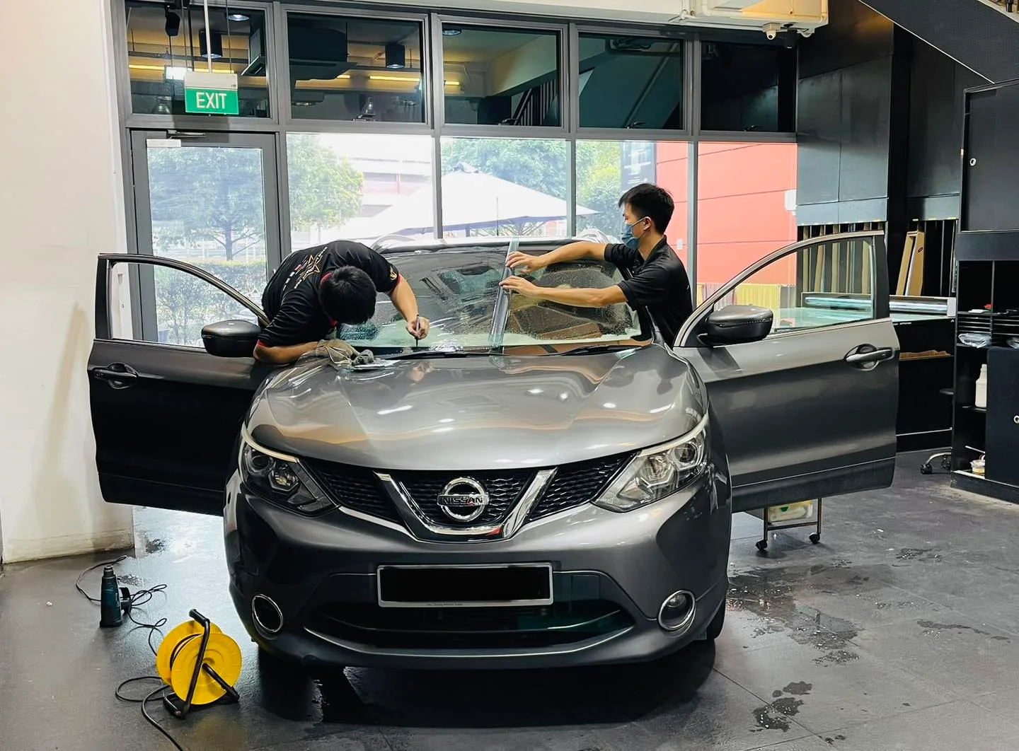 Grey Nissan Qashqai having windscreen film applied at Infratint Singapore