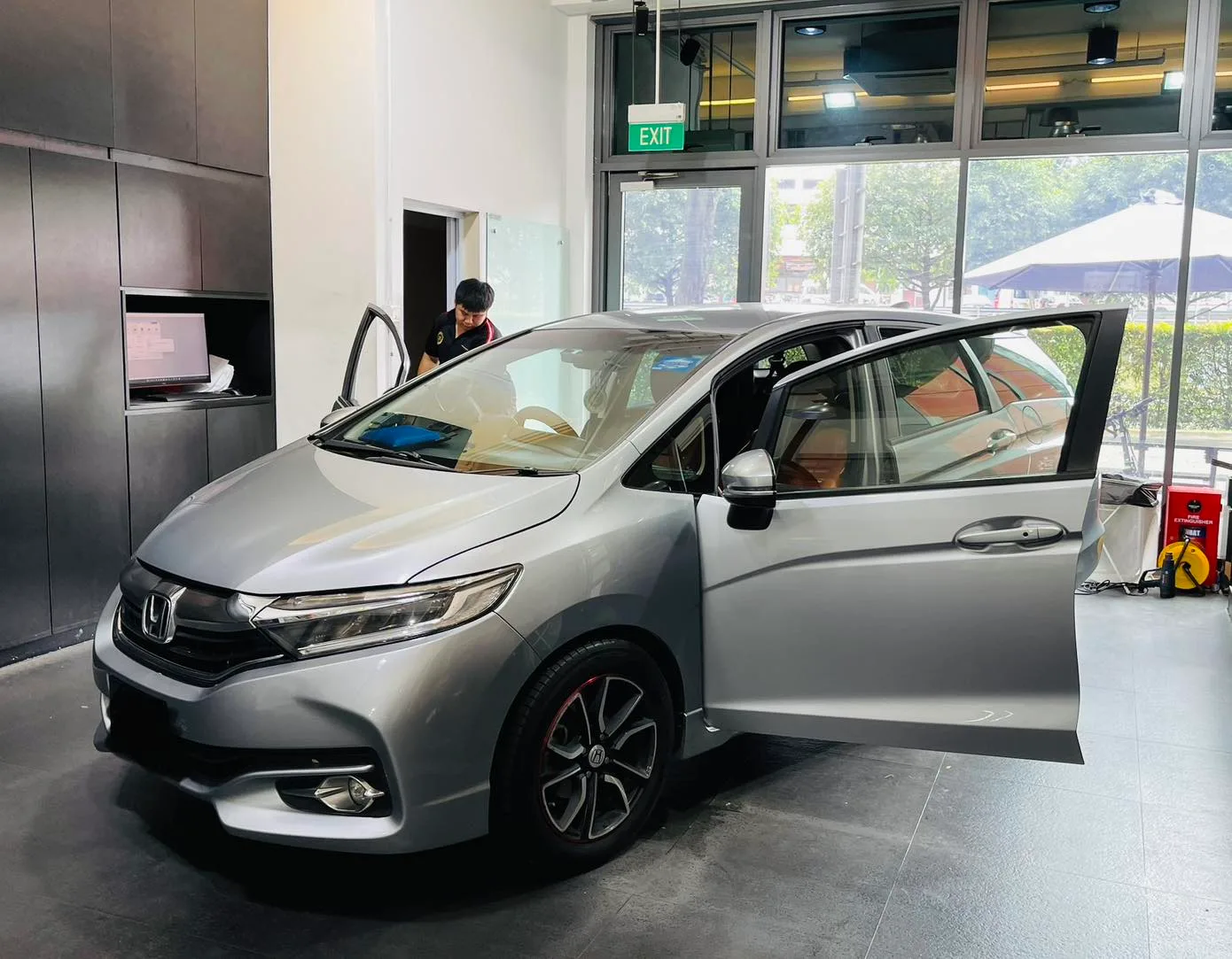 Silver Honda Shuttle in three-quarter view during window tinting at Infratint Singapore