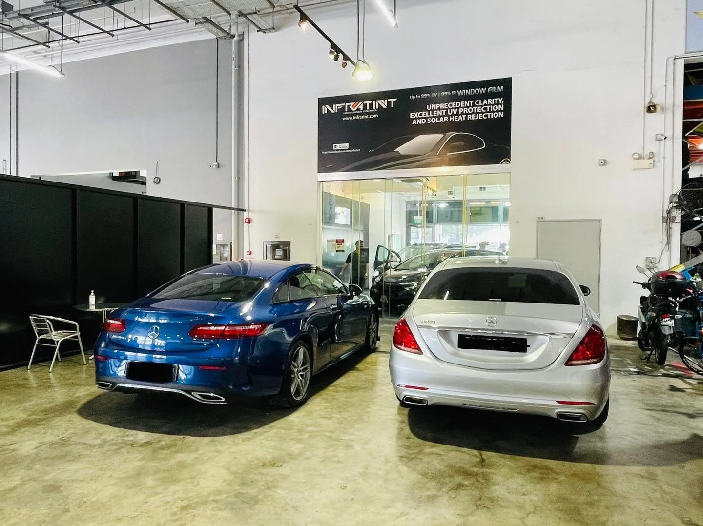 Blue coupe and silver Mercedes-Benz S-Class at Infratint Singapore awaiting window film
