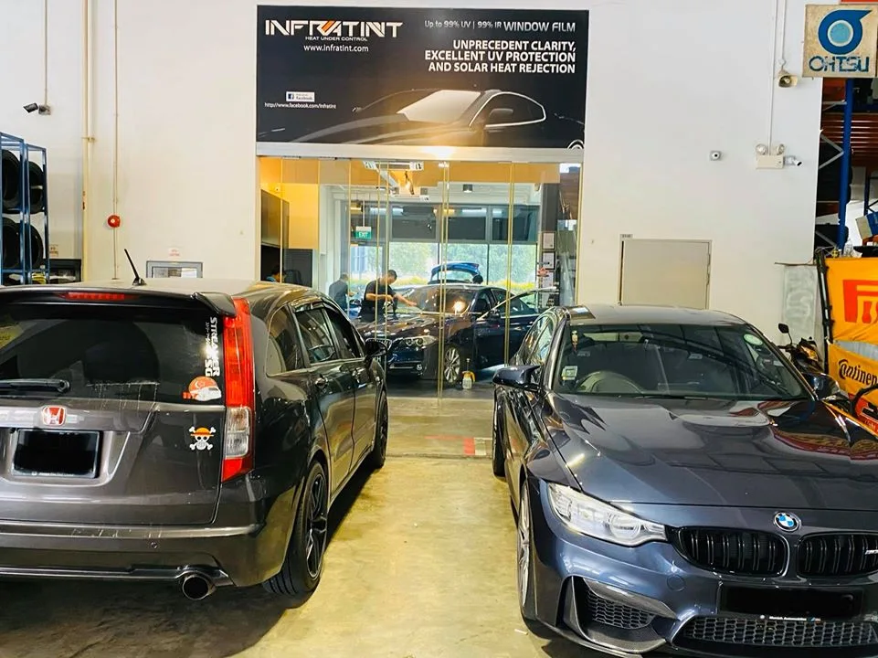 Black Honda Stream and grey BMW sedan at Infratint Singapore for window tinting